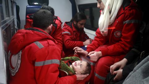 Syrian staff from the International Committee of the Red Cross evacuate a child from Eastern Ghouta on Wednesday.