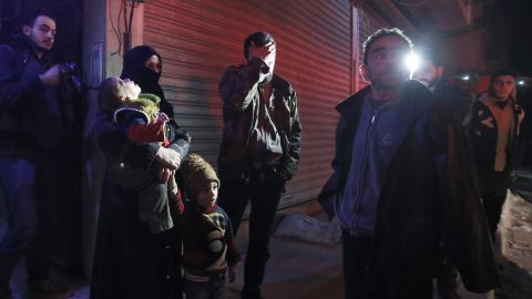Syrian civilians wait during an evacuation operation in Eastern Ghouta on Tuesday.
