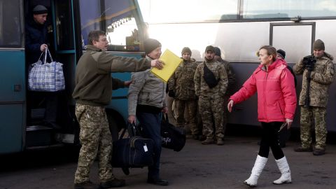 The first Ukrainian prisoners get off a bus Wednesday during a prisoner exchange at a checkpoint near the eastern Ukraine city of Horlivka.