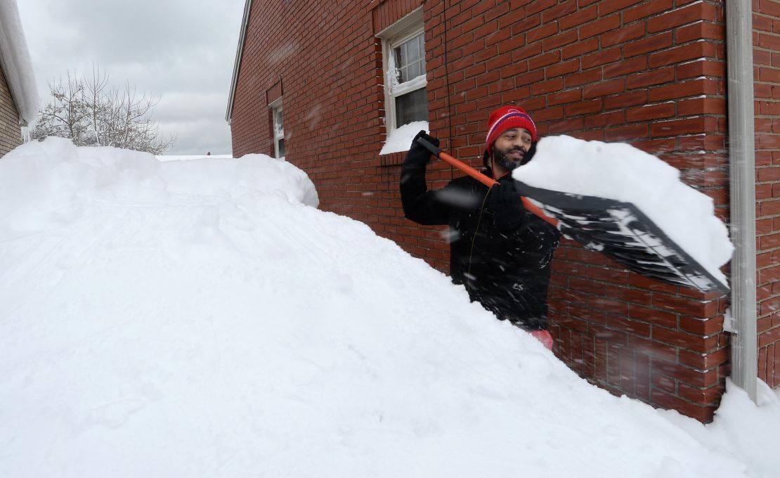 Patrick Harden clears snow from the roof of his car in Erie, Pennsylvania.