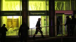 Firefighters respond to the blast at the Perekrestok supermarket in Kalinina Square. 