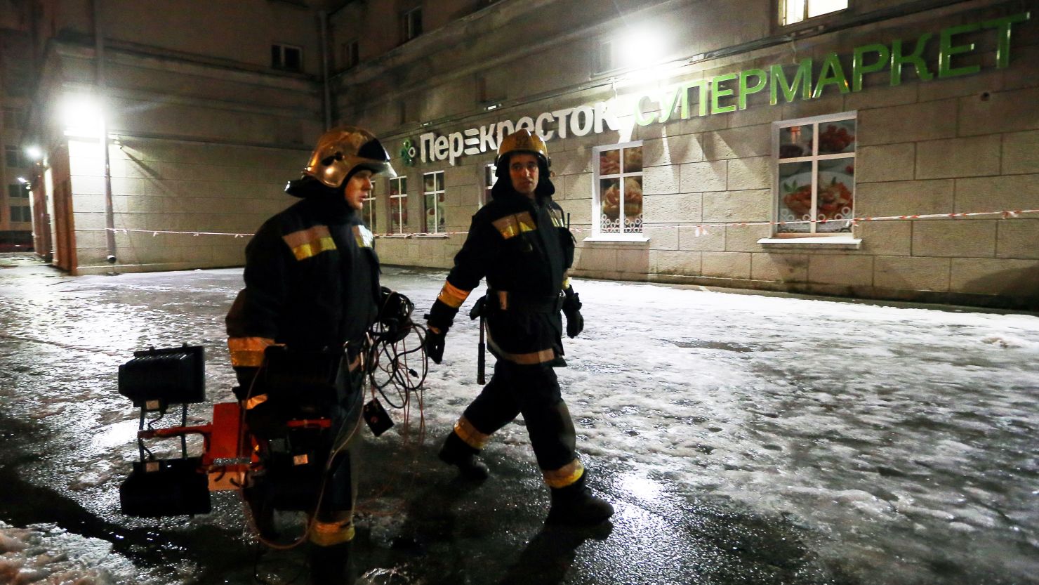 Firefighters outside a Perekrestok supermarket in St. Petersburg where an explosion injured 10 people. 