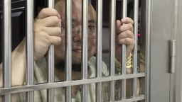 In this May 19, 2015 photo, Wu Gan also known as the Ultra Vulgar Butcher is seen behind bars at police station in Nanchang city in eastern China's Jiangxi province. A Chinese court on Tuesday, Dec 26, 2017 sentenced the prominent activist to eight years in prison for subversion. (AP Photo)