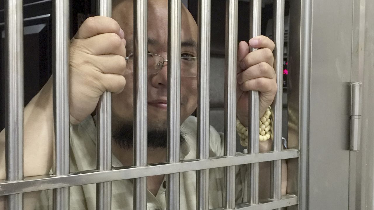 Wu Gan, also known as the Super Vulgar Butcher, seen behind bars at a police station in Nanchang city in eastern China's Jiangxi province in 2015.