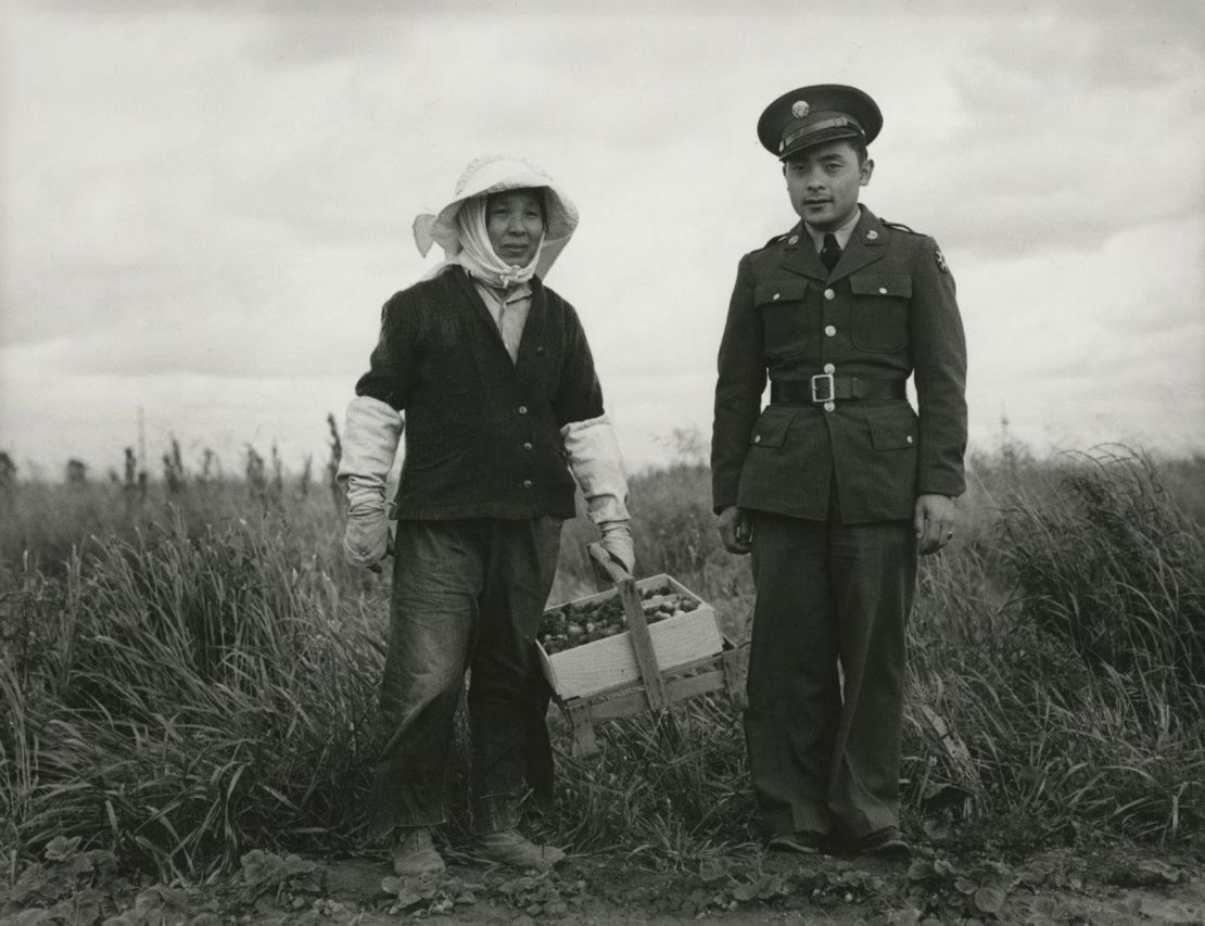 "A soldier and his mother in a strawberry field. He was furloughed to help his family prepare for their evacuation, Florin, CA" by Dorothea Lange (1942).