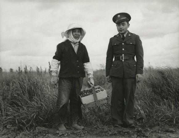 "A soldier and his mother in a strawberry field. He was furloughed to help his family prepare for their evacuation, Florin, CA," by Dorothea Lange (1942).