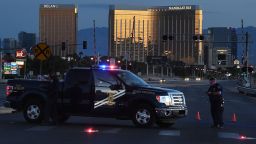 Police form a perimeter around the road leading to the Mandalay Hotel (background) after a gunman killed at least 50 people and wounded more than 400 others when he opened fire on a country music concert in Las Vegas, Nevada on October 2, 2017. 
The gunman who opened fire on concertgoers from 32nd floor of a Las Vegas hotel was found dead, apparently of a self-inflicted gunshot wound, when a police SWAT team burst in, authorities said Monday.They said at least eight weapons, including a number of long rifles, were found in the room from where 64-year-old Stephen Paddock rained automatic fire into thousands of terrified people attending a country music concert across the street."We believe the individual killed himself prior to our entry," Las Vegas Sheriff Joseph Lombardo said.
 / AFP PHOTO / Mark RALSTON        (Photo credit should read MARK RALSTON/AFP/Getty Images)