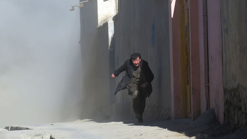 An Afghan man runs away as dust blows in the aftermath of the third blast at a Shiite cultural centre in Kabul on December 28, 2017.At least 40 people were killed and dozens more wounded in multiple blasts at a Shiite cultural centre in Kabul on December 28, officials said, in the latest deadly violence to hit the Afghan capital. / AFP PHOTO / SHAH MARAI        (Photo credit should read SHAH MARAI/AFP/Getty Images)