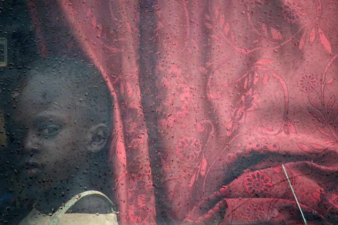 A South Sudanese child on a bus to a refugee settlement in Uganda.