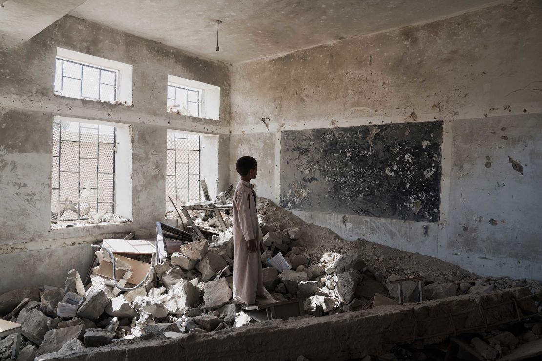 A student stands in the ruins of one of his bombed-out classrooms in Saada, Yemen, on April 24.