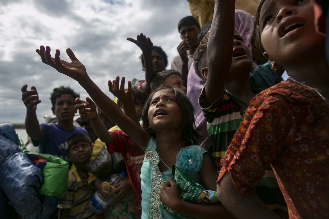 Rohingya children beg for food after arriving on a boat from Myanmar to Shah Porir Dip, Bangladesh, on September 14.