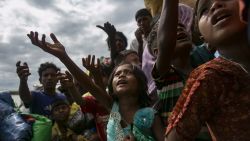 SHAH PORIR DIP, BANGLADESH - SEPTEMBER 14: Rohingya beg for food after arriving on a boat to Bangladesh on September 14, 2017 in Shah Porir Dip, Bangladesh. Around 370,000 Rohingya refugees have fled into Bangladesh since late August during the outbreak of violence in the Rakhine state. Myanmar's de facto leader Aung San Suu Kyi announced that she will miss next week's UN General Assembly as criticism on her handling of the Rohingya crisis grows while her government has been accused of ethnic cleansing. According to reports, the total death toll from Rohingya boat capsize incidents rose to 84 while many people have died trying to get out, including children and infants. (Photo by Allison Joyce/Getty Images)