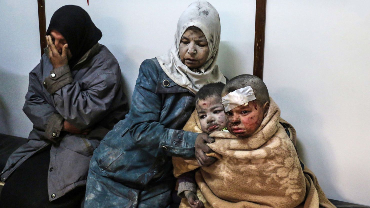 Injured children and women wait at a hospital following a reported strike by Syrian government forces near Damascus, on February 20.