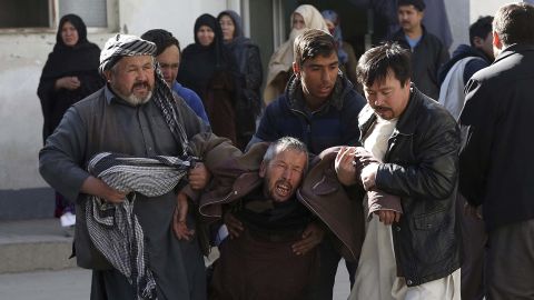A distraught man is carried away following the suicide attack in Kabul on Thursday.