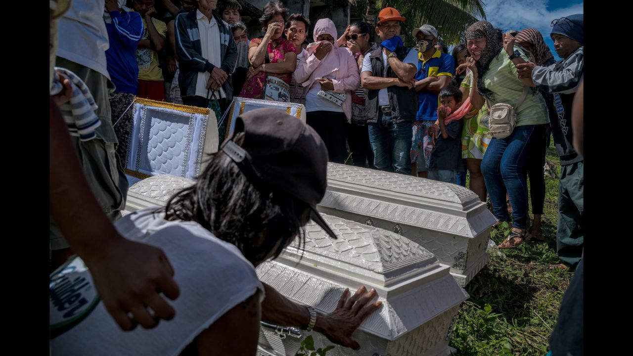 Family and friends mourn those who perished during Tropical Storm Tembin in Tubod, Philippines, on December 26.