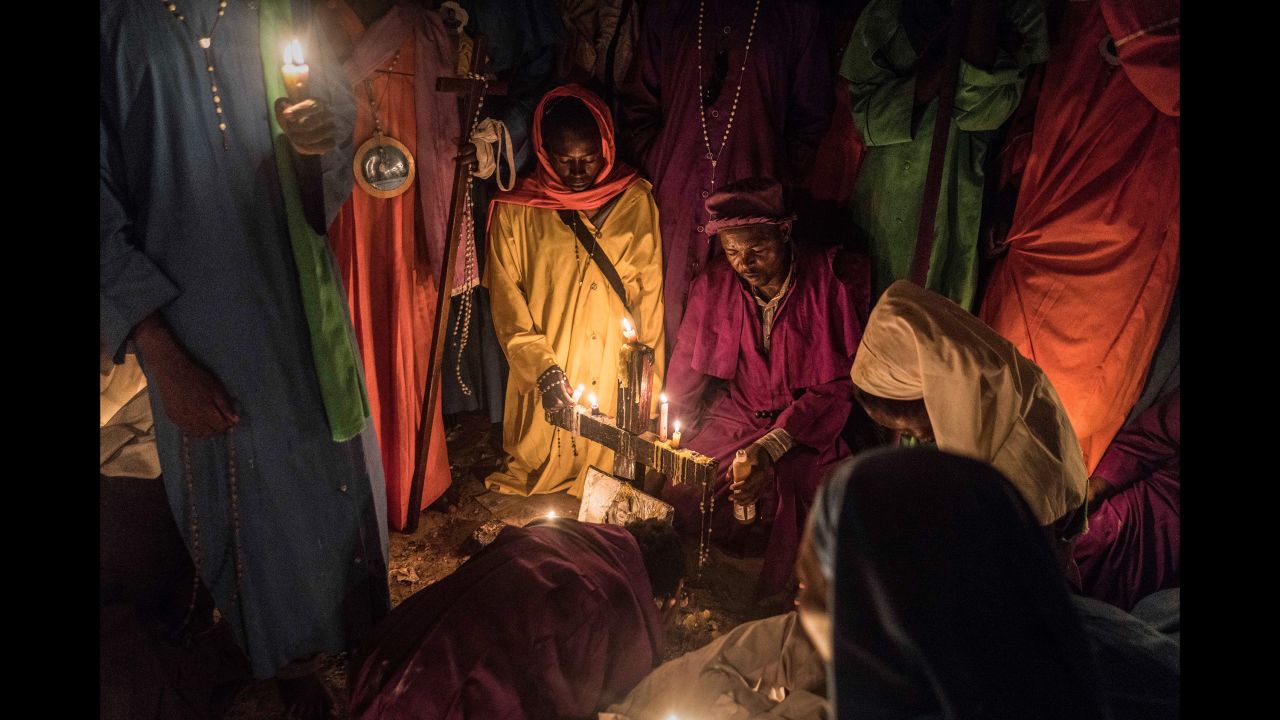 Members of Legio Maria of African Church Mission hold candles during their overnight Christmas Mass at a church near Ugunja, Kenya, early December 25.