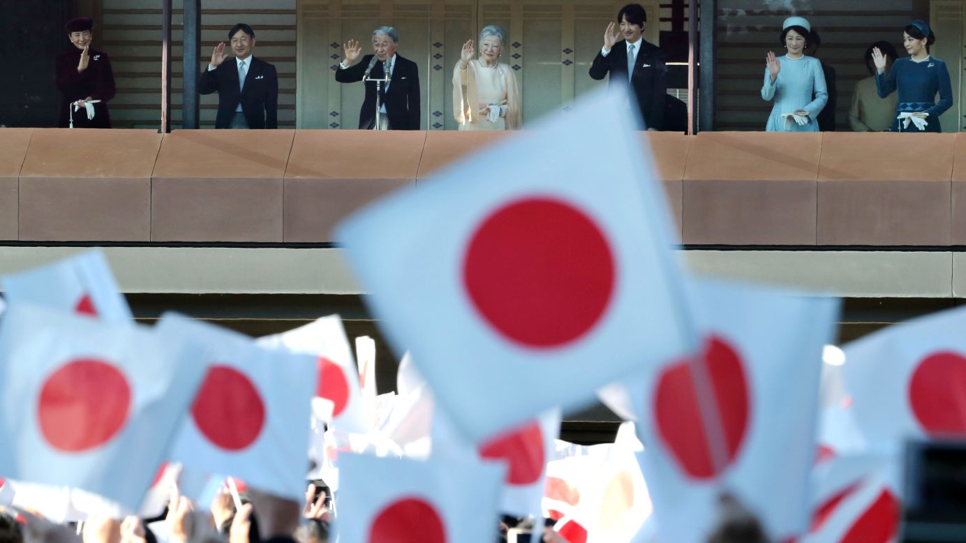 Japan's Emperor Akihito, third from left, waves with his family as well-wishers at the Imperial Palace in Tokyo celebrate his 84th birthday December 23.
