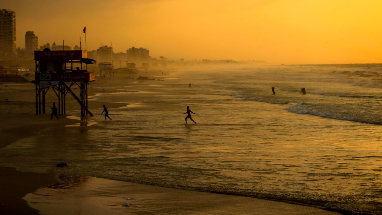 People walk on the beach of Gaza City at sunset on Sunday, December 24. <a href="http://www.cnn.com/2017/12/21/world/gallery/week-in-photos-1222/index.html" target="_blank">See last week in 34 photos.</a>