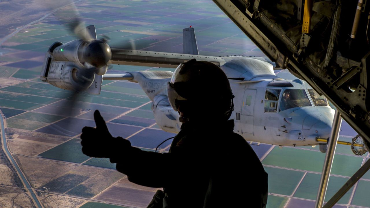 Marine Corps Cpl. Seth Witherup signals to a pilot during training at Naval Air Facility El Centro, Calif., Dec. 6, 2017. Witherup is a crewmaster assigned to Marine Aerial Refueler Transport Squadron 152. 