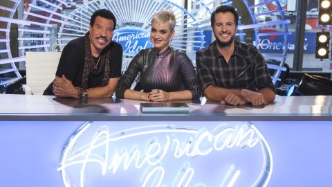 ABC's "American Idol" judge Luke Bryan, right, will sit out the program's first live show after testing positive for Covid. Judges Lionel Richie (left) and Katy Perry (center) will continue on with Paula Abdul serving as a guest judge. 