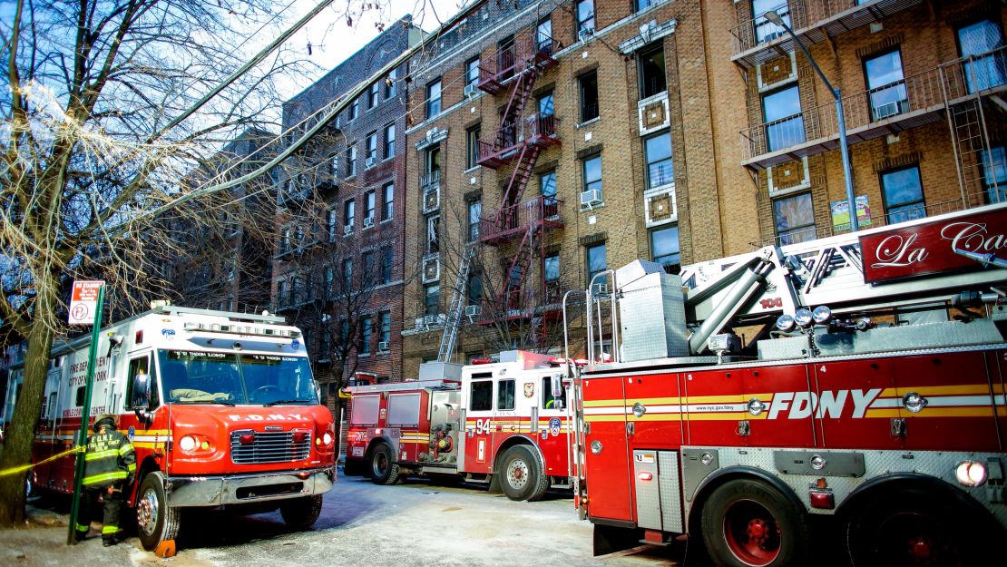 Fire Department of New York personnel work at the scene of an apartment fire in the Bronx borough of New York City on December 29, 2017.
