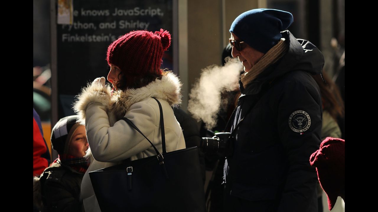People walk through a frigid New York City on Thursday, December 28.