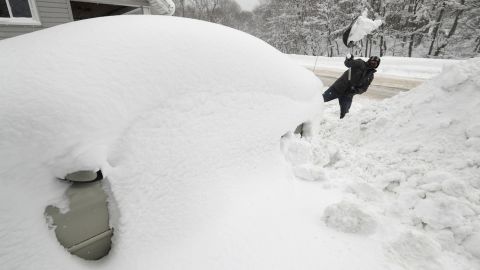 A man digs his car out in his driveway in Erie, Pennsylvania, on December 29.