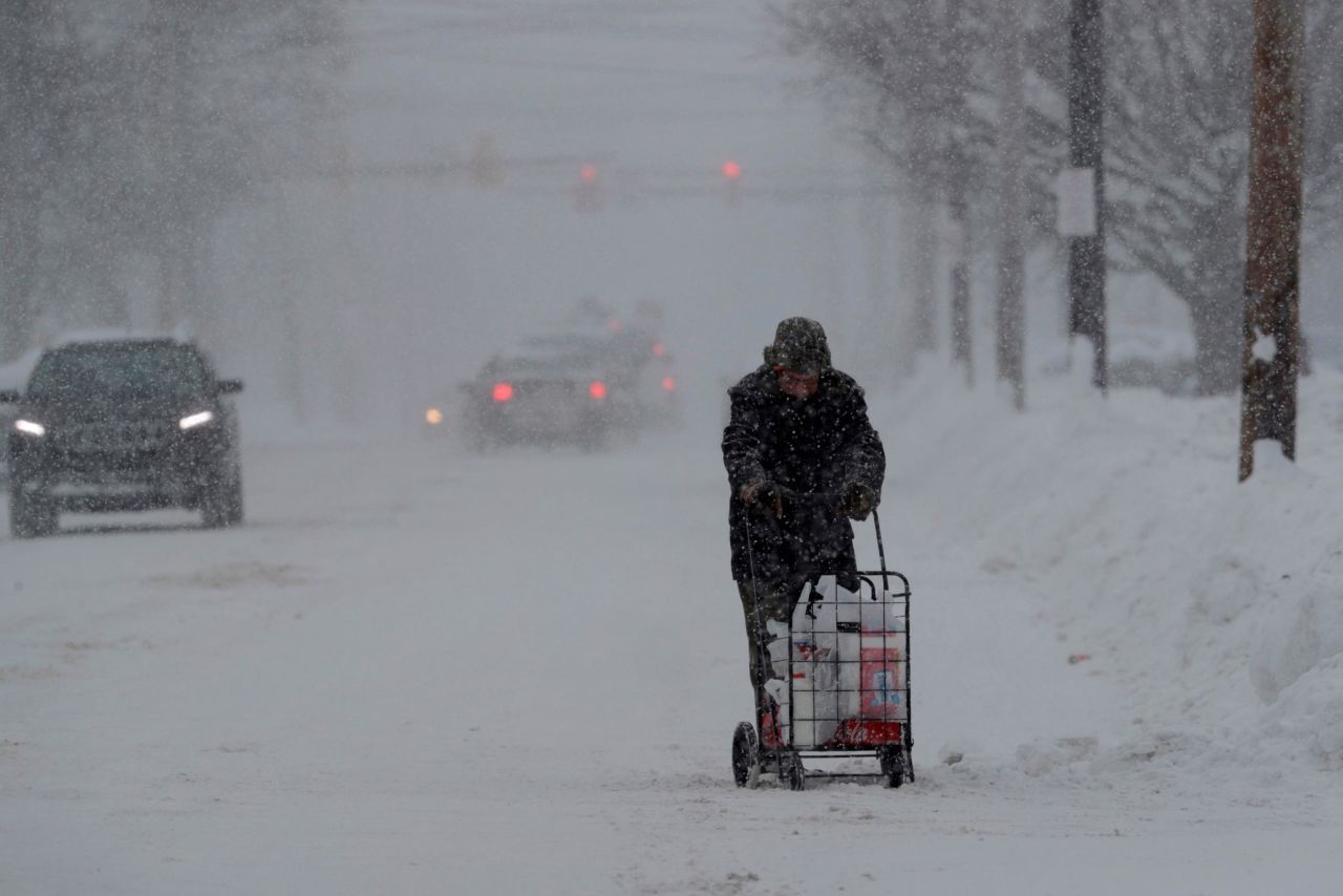 A man in Erie, Pennsylvania, walks with his groceries in a cart on December 29.