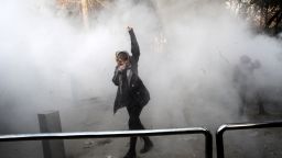 An Iranian woman raises her fist amid the smoke of tear gas at the University of Tehran during a protest driven by anger over economic problems, in the capital Tehran on December 30, 2017.
Students protested in a third day of demonstrations sparked by anger over Iran's economic problems, videos on social media showed, but were outnumbered by counter-demonstrators. / AFP PHOTO / STR        (Photo credit should read STR/AFP/Getty Images)