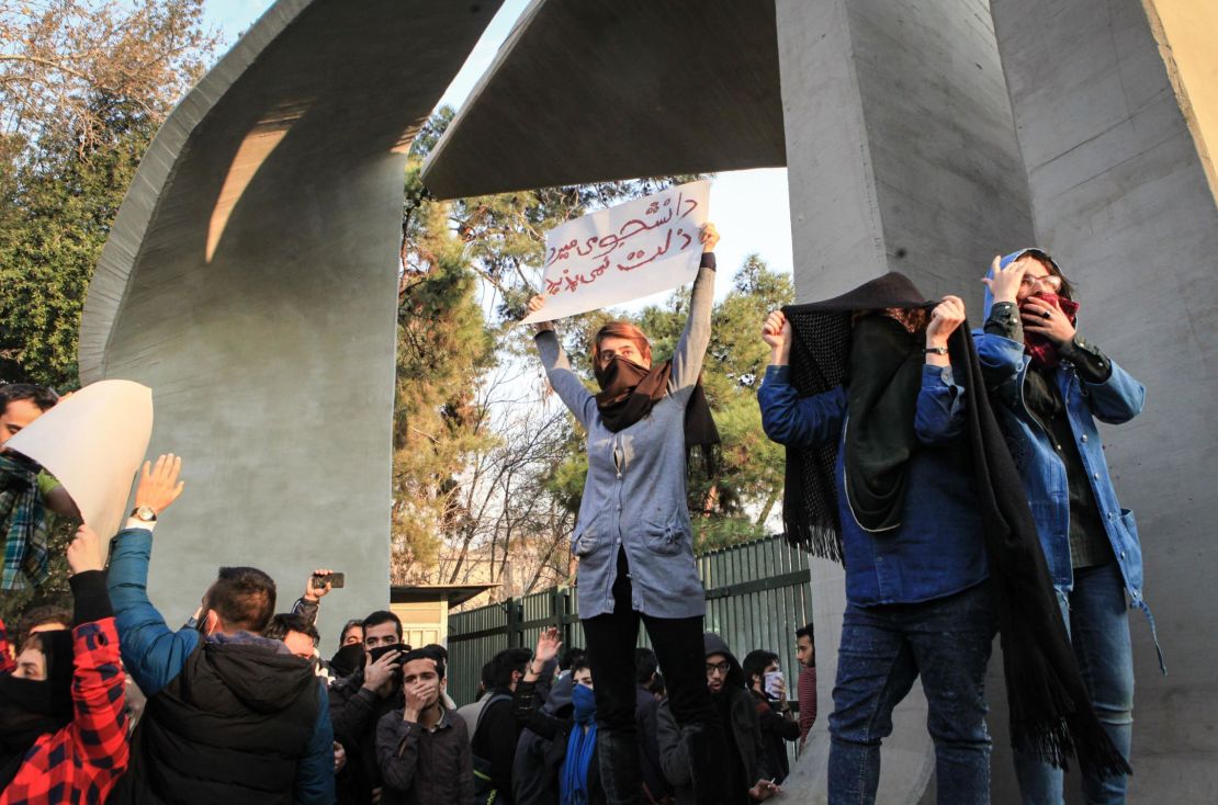 Students hold placards in protest at the University of Tehran.