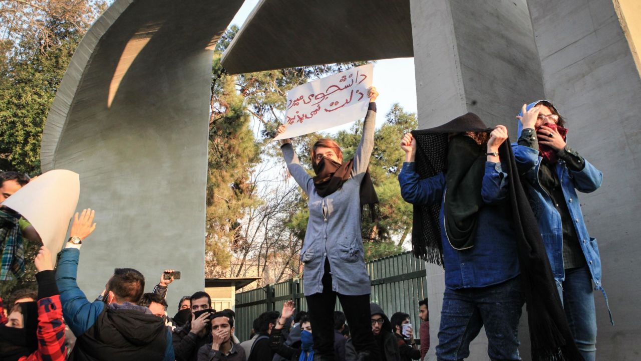 Students hold placards in protest at the University of Tehran.