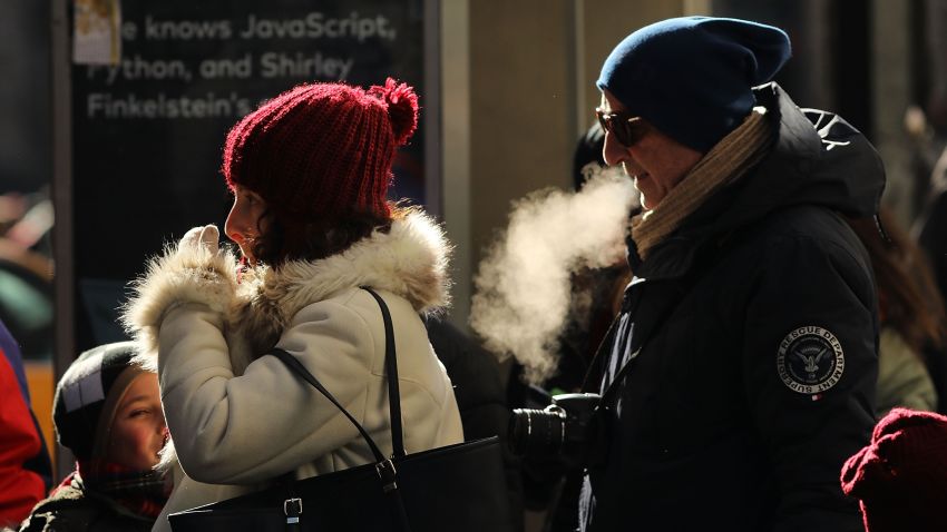 People walk through a frigid Manhattan on December 28, 2017 in New York City. Dangerously low temperatures and wind chills the central and eastern United States are making outdoor activity difficult for many Americans.  Little relief from the below normal temperatures is expected the first week of the New Year.   