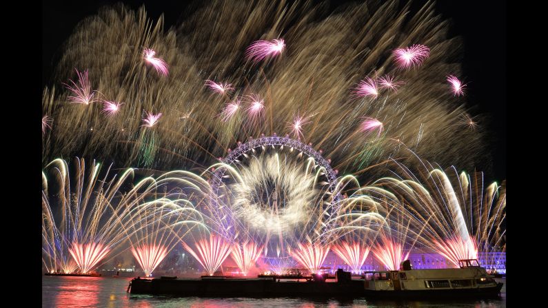 Fireworks light up the sky over the London Eye in central London.