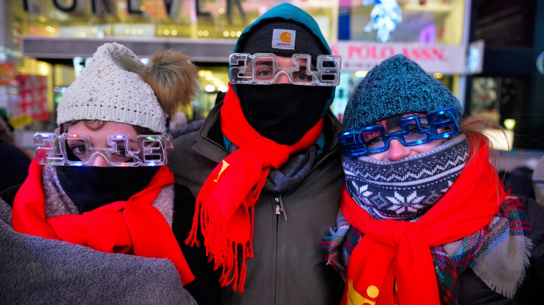 Revelers awaiting New York's New Year's Eve celebrations bundled up as they gathered in Times Square.