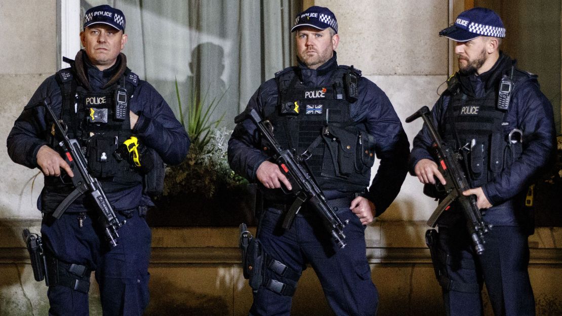 Armed police officers stand guard in Westminster, ahead of New Year's celebrations in central London.