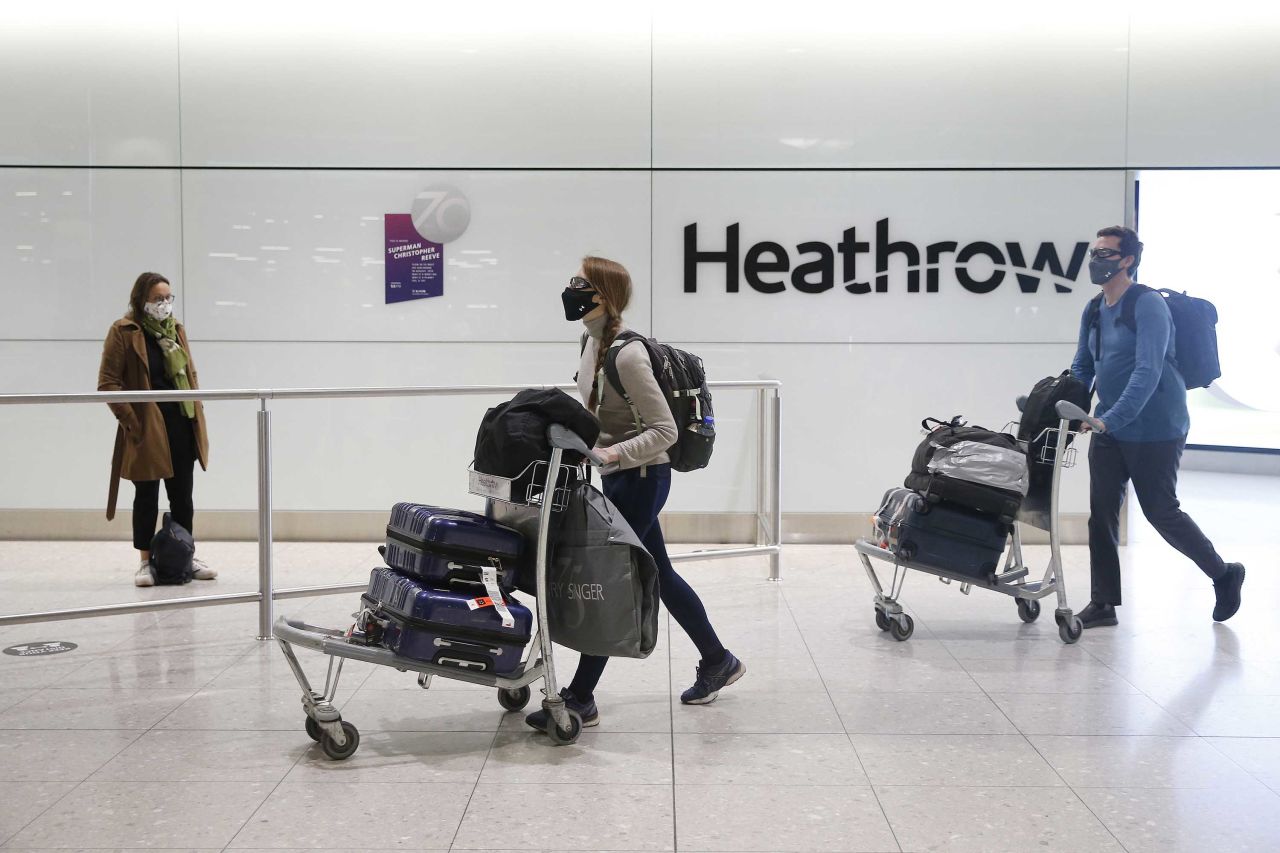 Travelers arrive at Heathrow Airport on January 30, in London, England. 