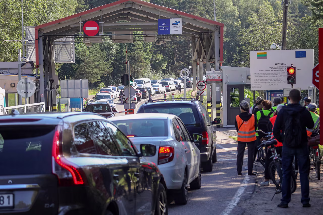 People wait at the Šumskas border crossing point between Lithuania and Belarus on August 12. 