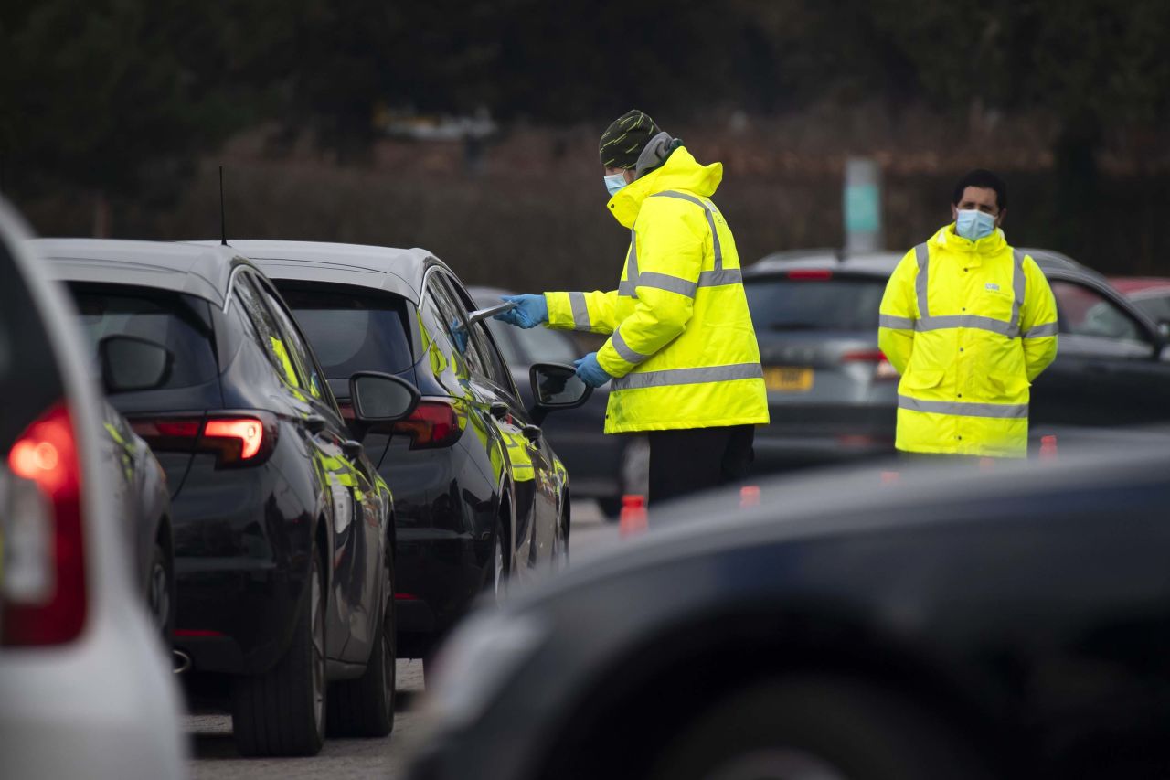 Workers hand out coronavirus testing kits in Bristol, England, on March 1, after three returning residents of a neighboring region were found to have been infected with the Covid-19 variant first detected in Brazil. 