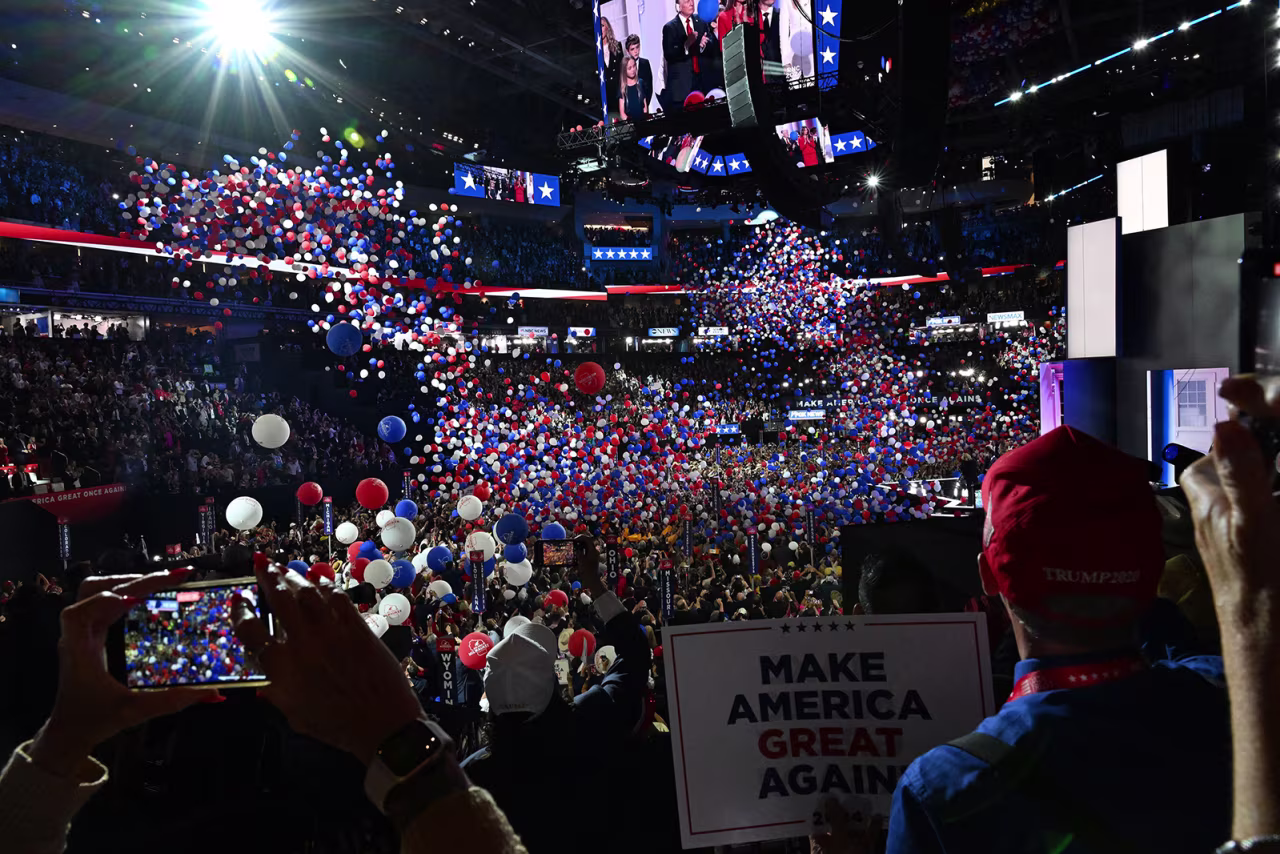 Convention attendees take photos and videos at the end of Trump's speech on Thursday.