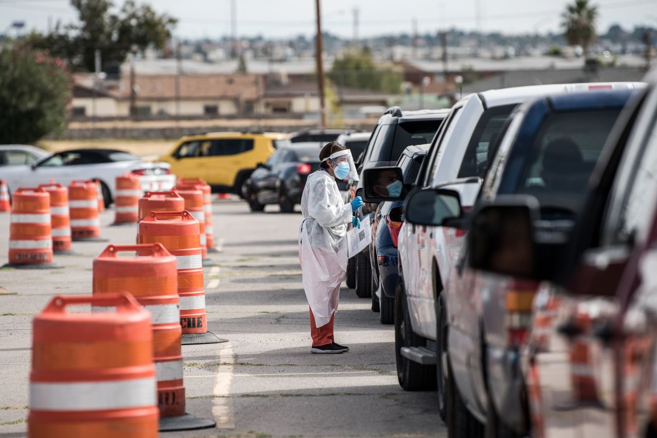 An attendant talks to a person waiting in their car at a coronavirus testing site at Ascarate Park on October 31, in El Paso, Texas. 