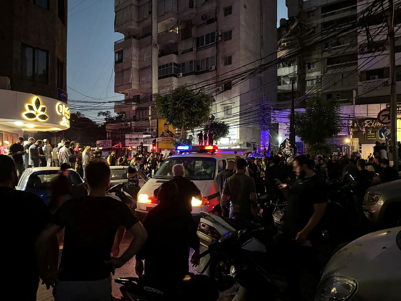 People gather near a site hit by what security sources said was a strike on Beirut's southern suburbs, Lebanon on July 30.