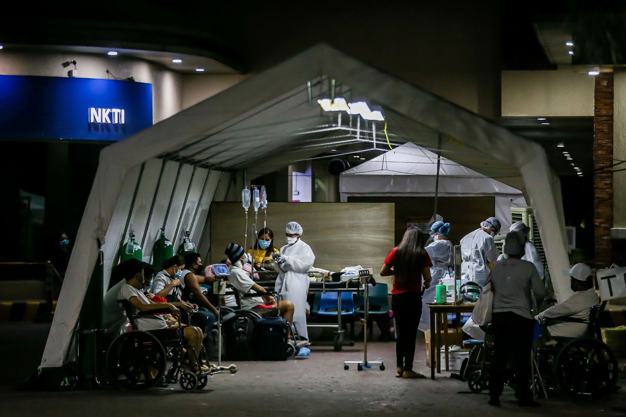 Medical workers screen patients for coronavirus outside of a hospital in Quezon City, Philippines, on March 28.