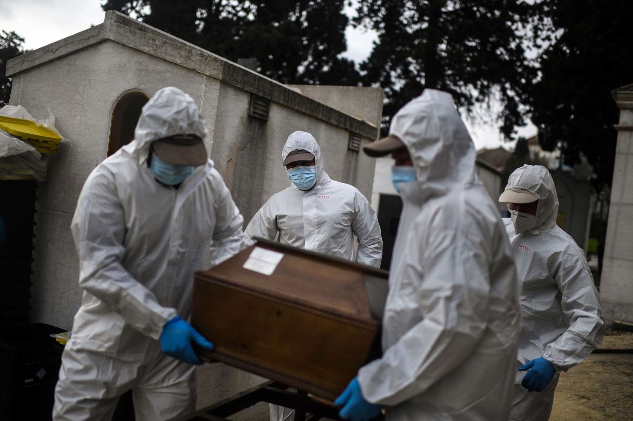 Grave diggers carry the coffin of a Covid-19 victim at the Alto de Sao Joao cemetery in Lisbon, Portugal, on February 18.