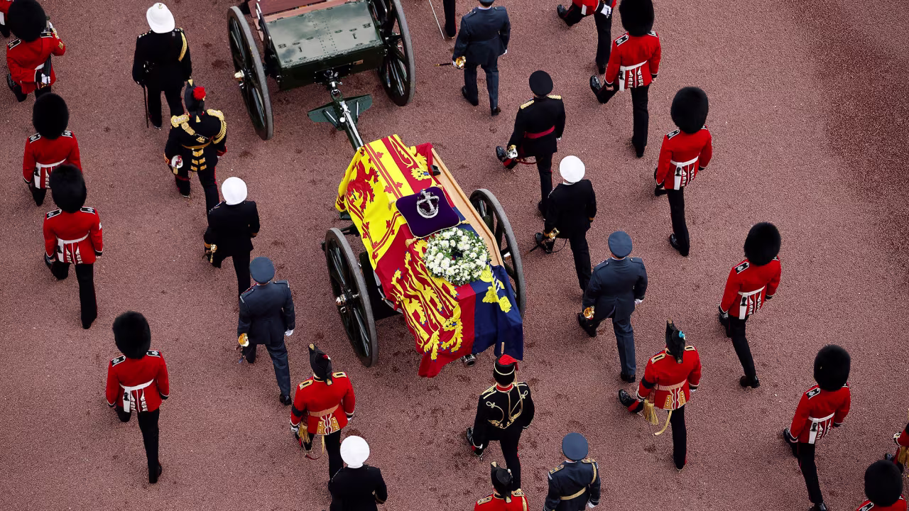 The Queen's coffin is covered with the Royal Standard as it is carried to Westminster Hall.