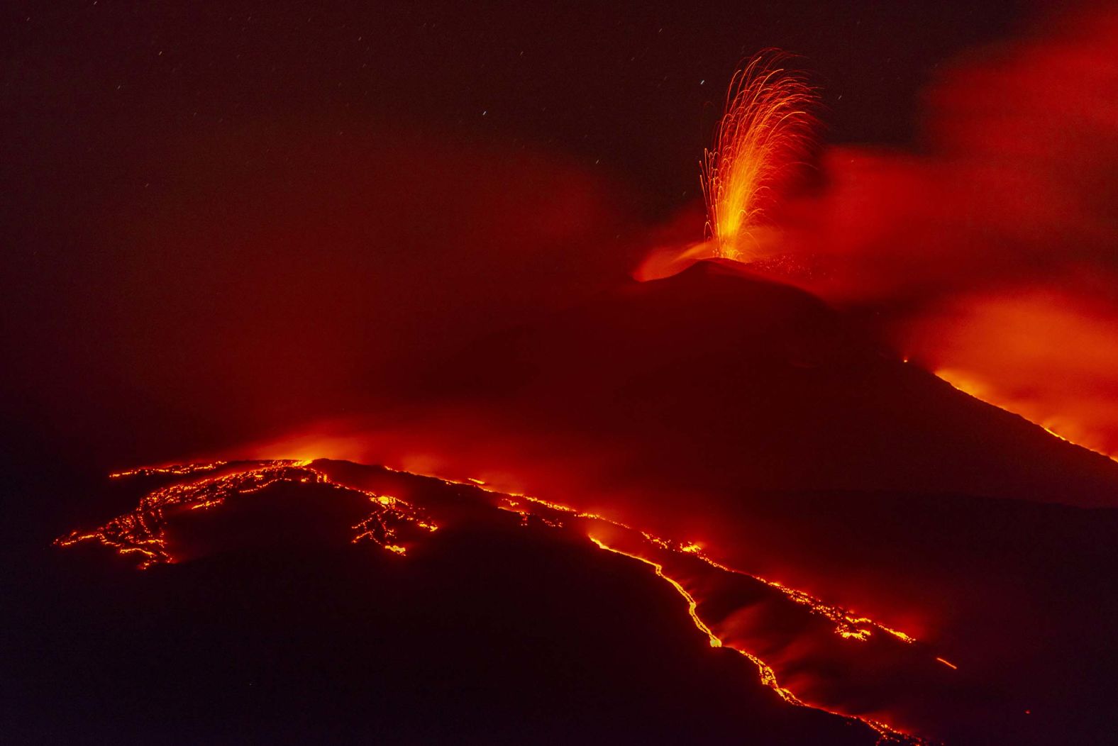 Eruptive activity continues on Mount Etna, where two lava flows descend on the slopes of the volcano near Catania, Italy, on Tuesday, August 26.