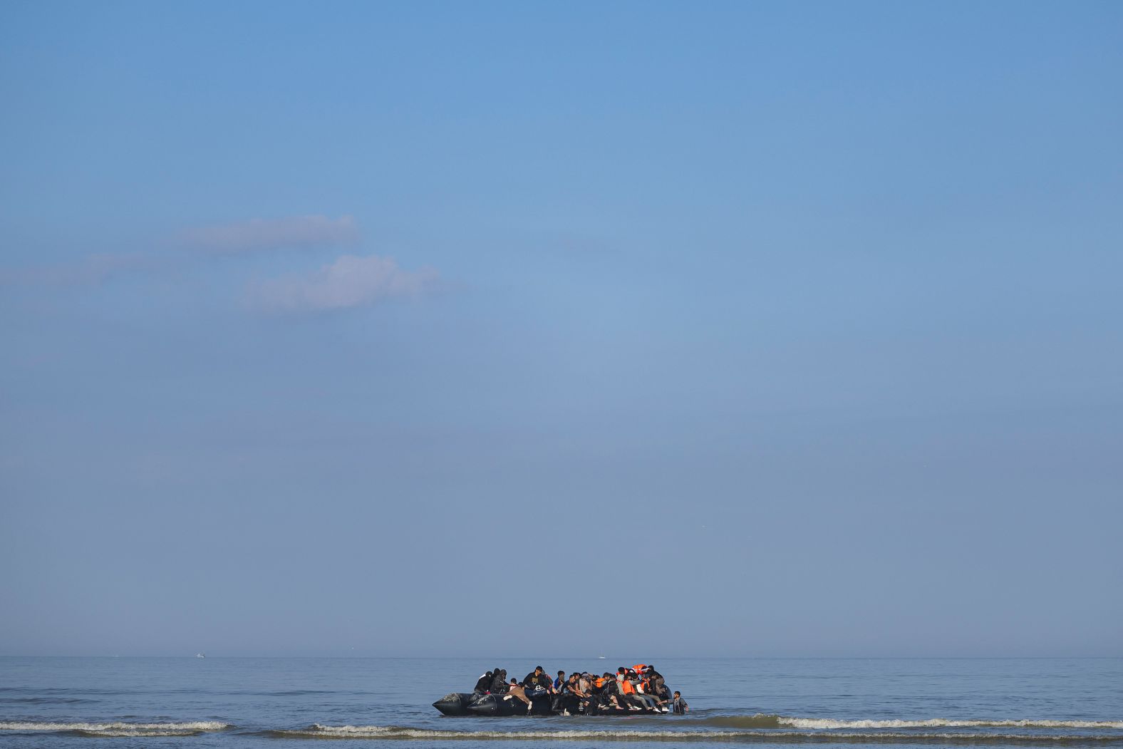 Migrants board a boat on the coast of Équihen-Plage, France, in an attempt to cross the English Channel on Monday, June 30.