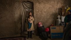 GUZARA, AFGHANISTAN - JULY 5: Fatima, 30, holds her daughter Mohana, 1, in the house of relatives in the village of Andisha, Guzara district, Herat province, where they will sleep overnight as they have nowhere else to go after arriving from the Iranian border following their deportation on July 5, 2025, in Guzara, Afghanistan. She arrived with a group of approximately 20 people who will all be hosted in the same house. According to the village elder, more than 500 families have returned to Andisha in the past week, a village previously home to around 8,000 families. Despite limited resources, residents have taken in returnee families, offering space in their homes or yards, regardless of overcrowding. Over 256,000 Afghans left Iran for Afghanistan last month, according to the UN's International Organization for Migration (IOM), ahead of a July 6 deadline imposed by the Iranian government for all undocumented Afghans to leave the country. Numbers have continued to rise, peaking at 43,000 returnees in a single day on July 1. UN agencies and NGOs have been sounding the alarm, saying that critical funding gaps limit their ability to provide assistance to returnees. The number of Afghans in Iran had swelled in recent years after the Taliban regained control of the country in 2021. The wave of recent returns, which has been exacerbated by the recent war between Israel and Iran, are overwhelming humanitarian provisions at the border, according to the UN's refugee co-ordinator for Afghanistan. Many NGOs that provide such humanitarian relief in Afghanistan are also grappling with cuts to foreign aid budgets, most notably the cancellation of programs funded by USAID, the United States Agency for International Development. (Photo by Elise Blanchard/Getty Images)