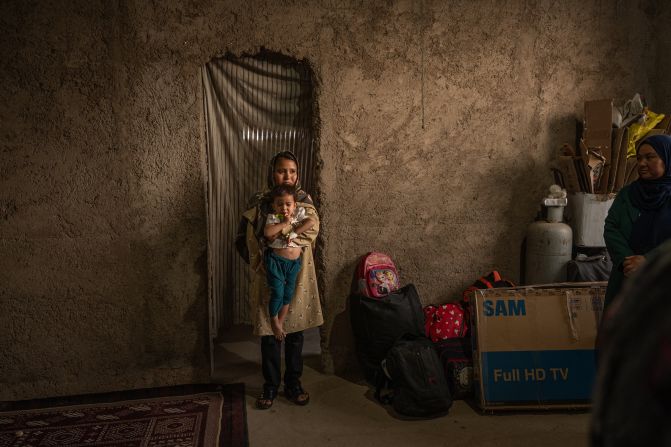 Fatima holds her 1-year-old daughter, Mohana, in the Afghan village of Andisha after they arrived from Iran on Saturday, July 5. Iran set a July 6 deadline for all undocumented Afghans to leave the country. More than 250,000 Afghans returned from Iran last month, according to the UN's International Organization for Migration.