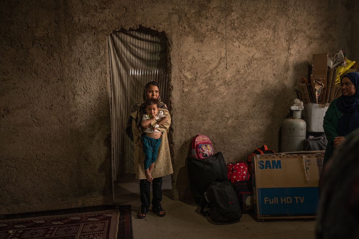 Fatima holds her 1-year-old daughter, Mohana, in the Afghan village of Andisha after they arrived from Iran on Saturday, July 5. Iran set a July 6 deadline for all undocumented Afghans to leave the country. More than 250,000 Afghans returned from Iran last month, according to the UN's International Organization for Migration.
