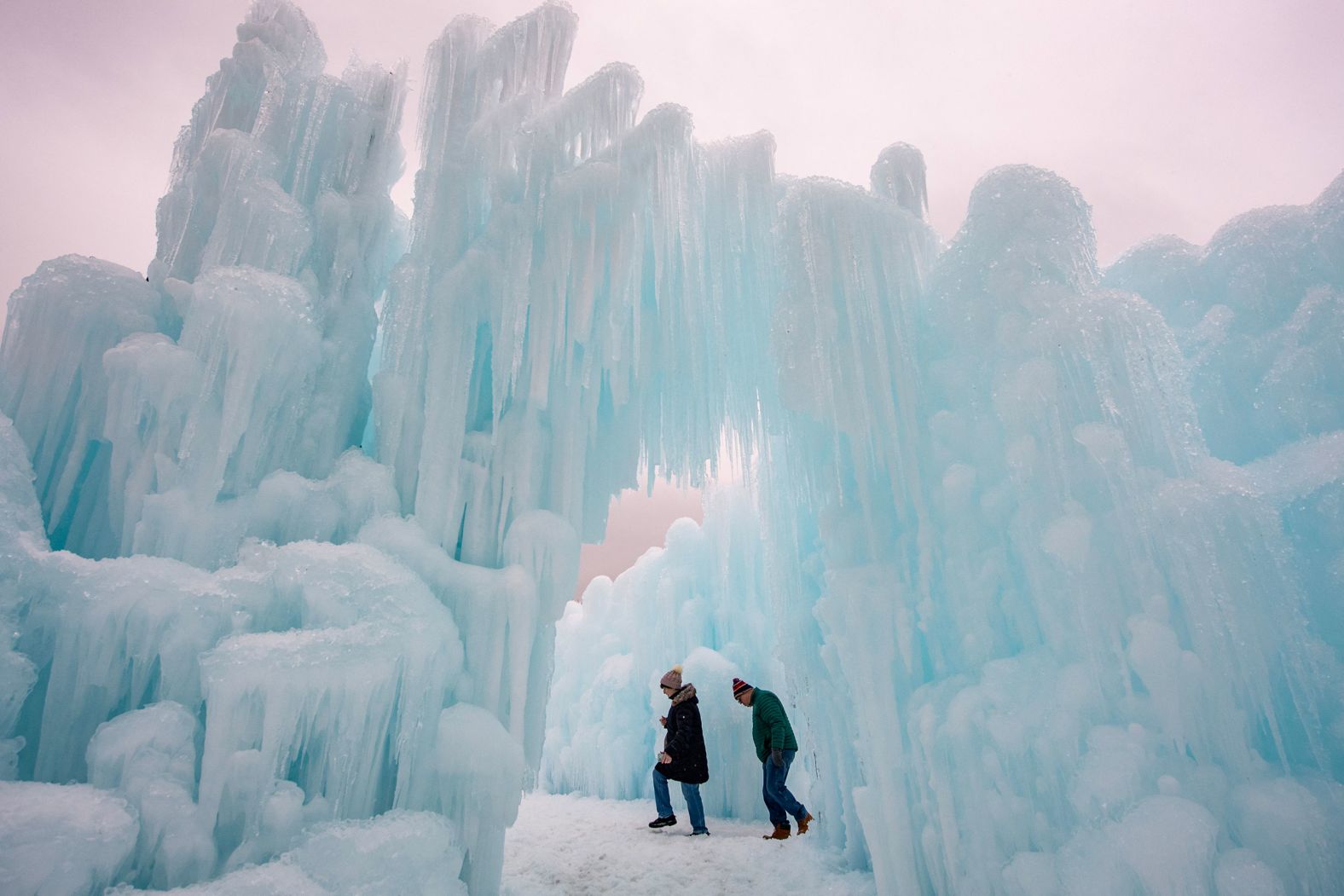 People explore the ice walls, trails and caverns at the Ice Castles tourist attraction in North Woodstock, New Hampshire, on Thursday, February 1.
